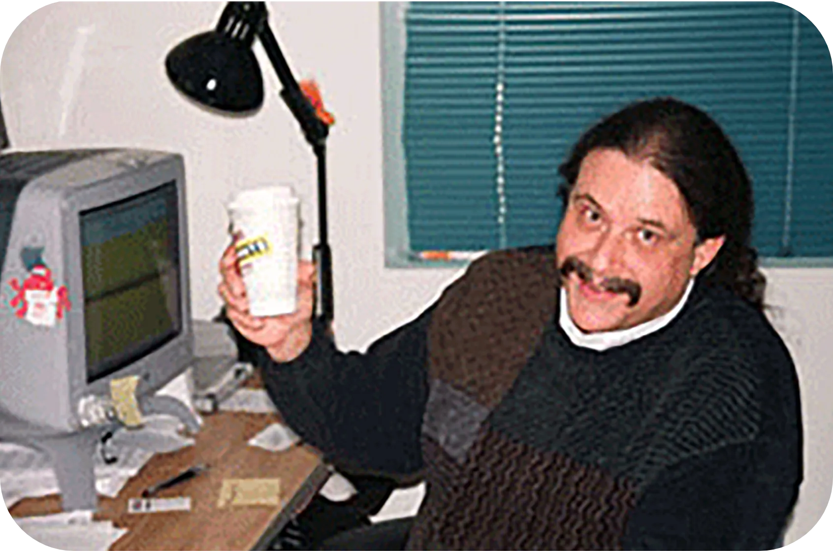 A mentor from the early days raising a coffee cup at his desk